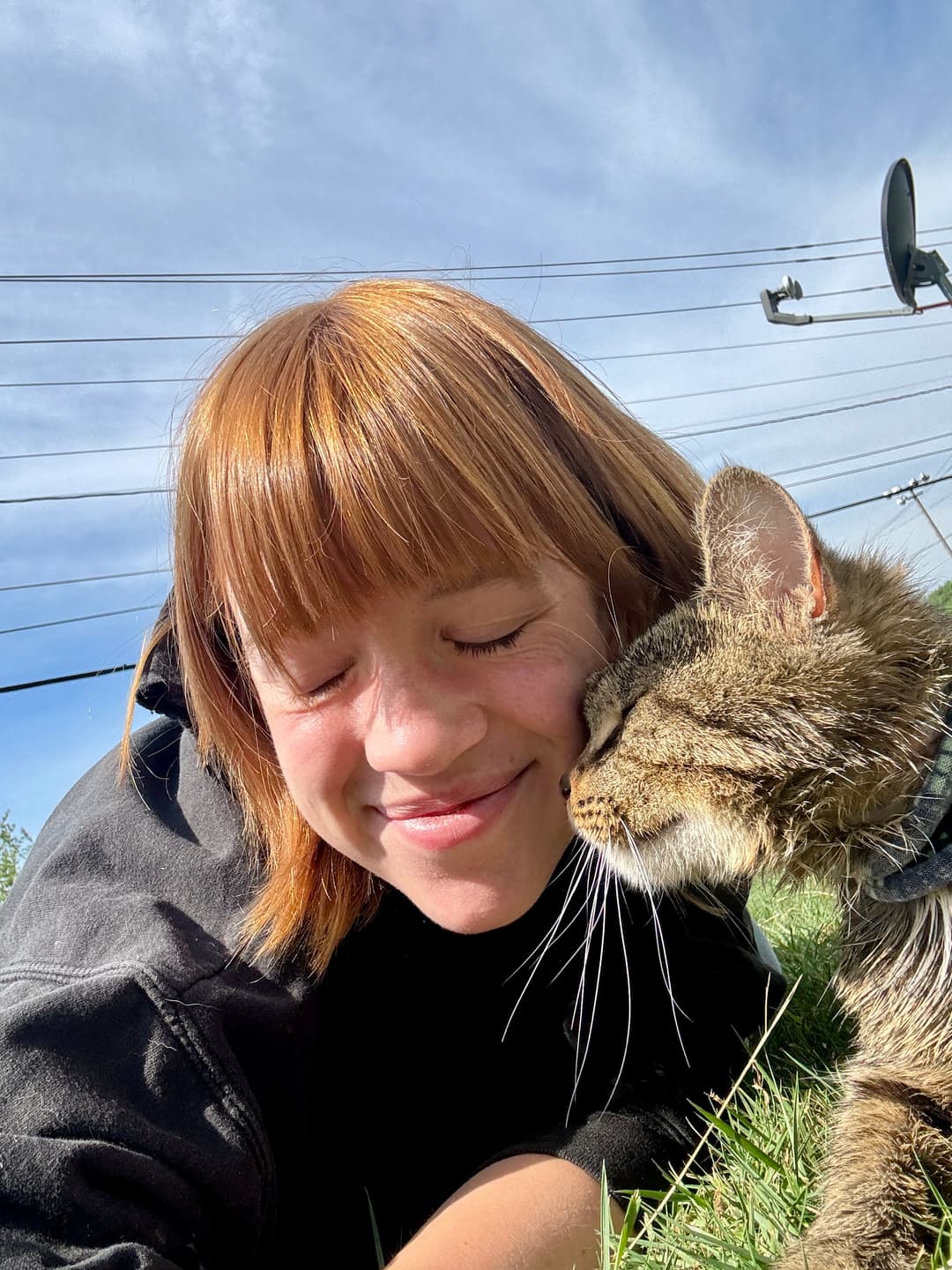 Kayla smiling with her cat
